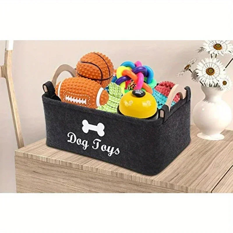 Felt dog toy storage bin filled with pet toys on table, organizer basket for keeping dog toys and accessories neat and easy to access